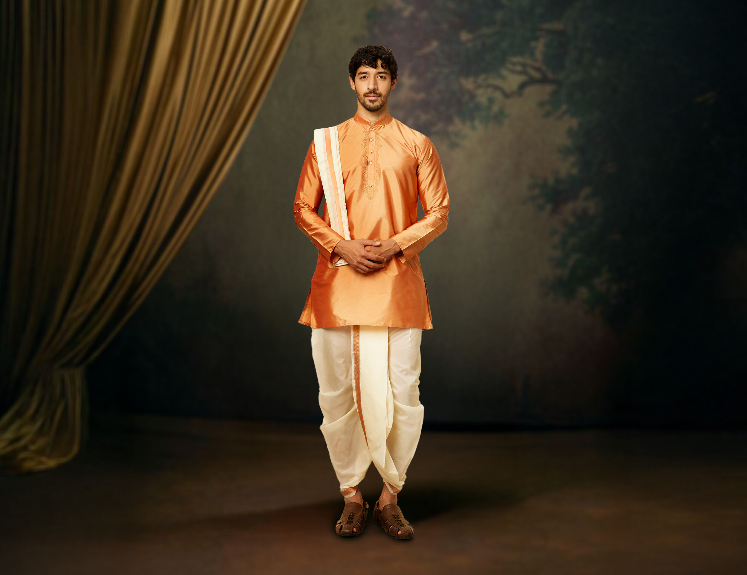 Elegant man dressed in a red kurta with stylish dhoti pants, creating a perfect fusion of classic and contemporary fashion